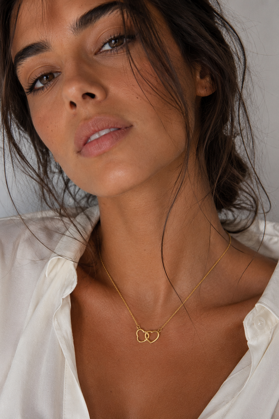 Colgante corazones unidos dorado